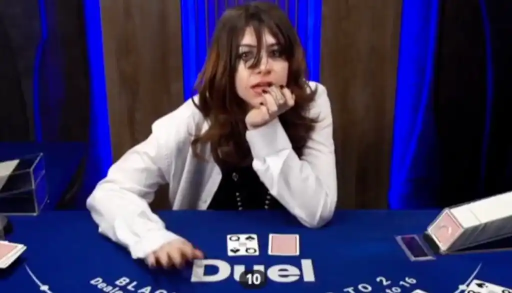 Annika, aka fascist.eth, sitting at a Duel.com blackjack table in a white blazer