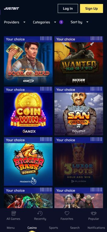 JustBit Casino slot games interface featuring Book of Dead, San Quentin xWays, Bigger Bass Bonanza, and other popular titles with provider filtering options