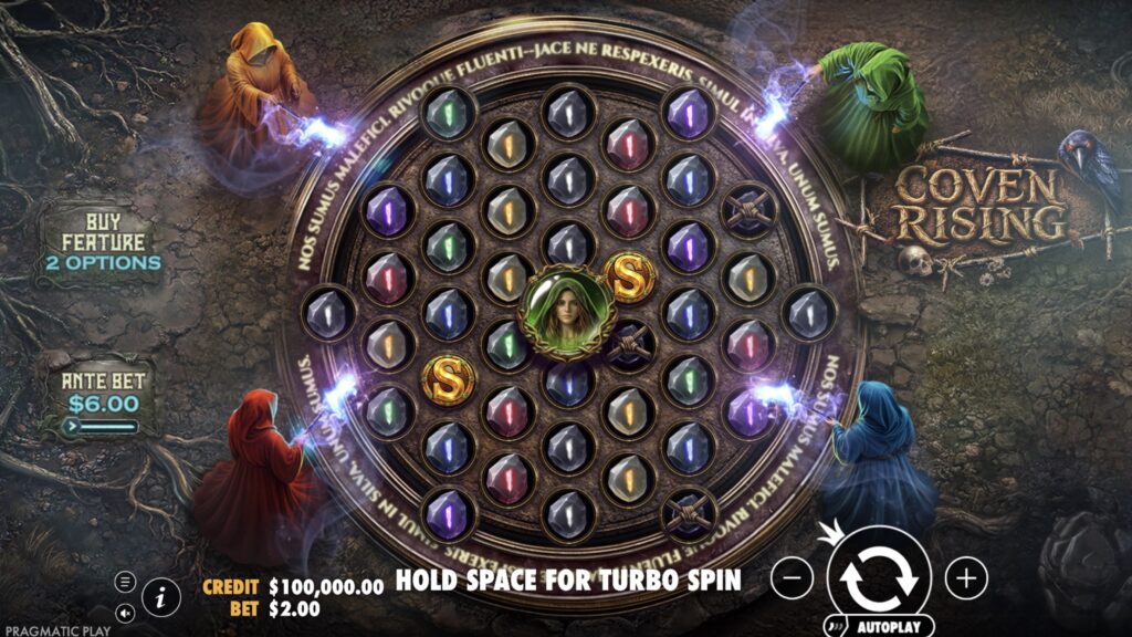 Coven Rising slot base game showing the diamond-shaped 1-4-7-6-7-6-7-4-1 grid filled with coloured gemstone symbols and a Green Witch modifier in the centre position, with four robed witches casting spells at the corners of a circular ritual area, Ante Bet and Buy Feature buttons on the left.
