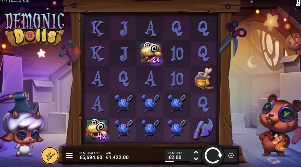 Demonic Dolls slot gameplay showing a large wool cluster win with two Wild Rattle symbols carrying 2x and 4x multipliers on a 5x5 grid